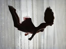 Immagine di una persona che sembra cadere da una scala nel sonno, rappresentando il concetto di sognare di precipitare